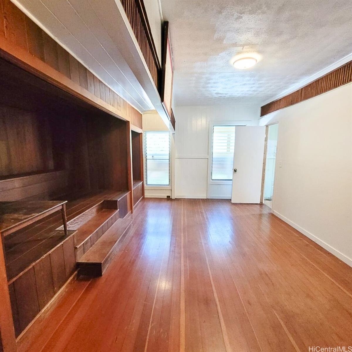 82 Hoku Street, Unit D Hilo, HI 96720 - Photo 3 of 15 a view of a room with wooden floor