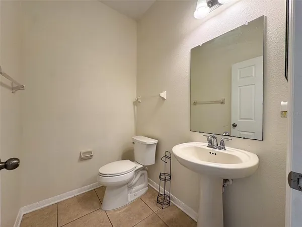 a bathroom with a sink toilet and a mirror