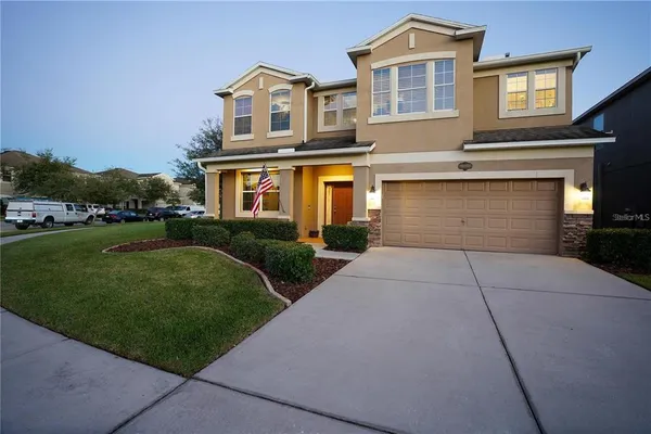 a front view of a house with a yard and garage