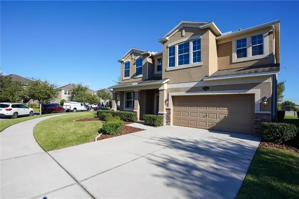 a front view of a house with a yard and garage