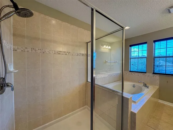 a bathroom with a tub and shower
