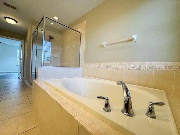a bathroom with a tub and a sink