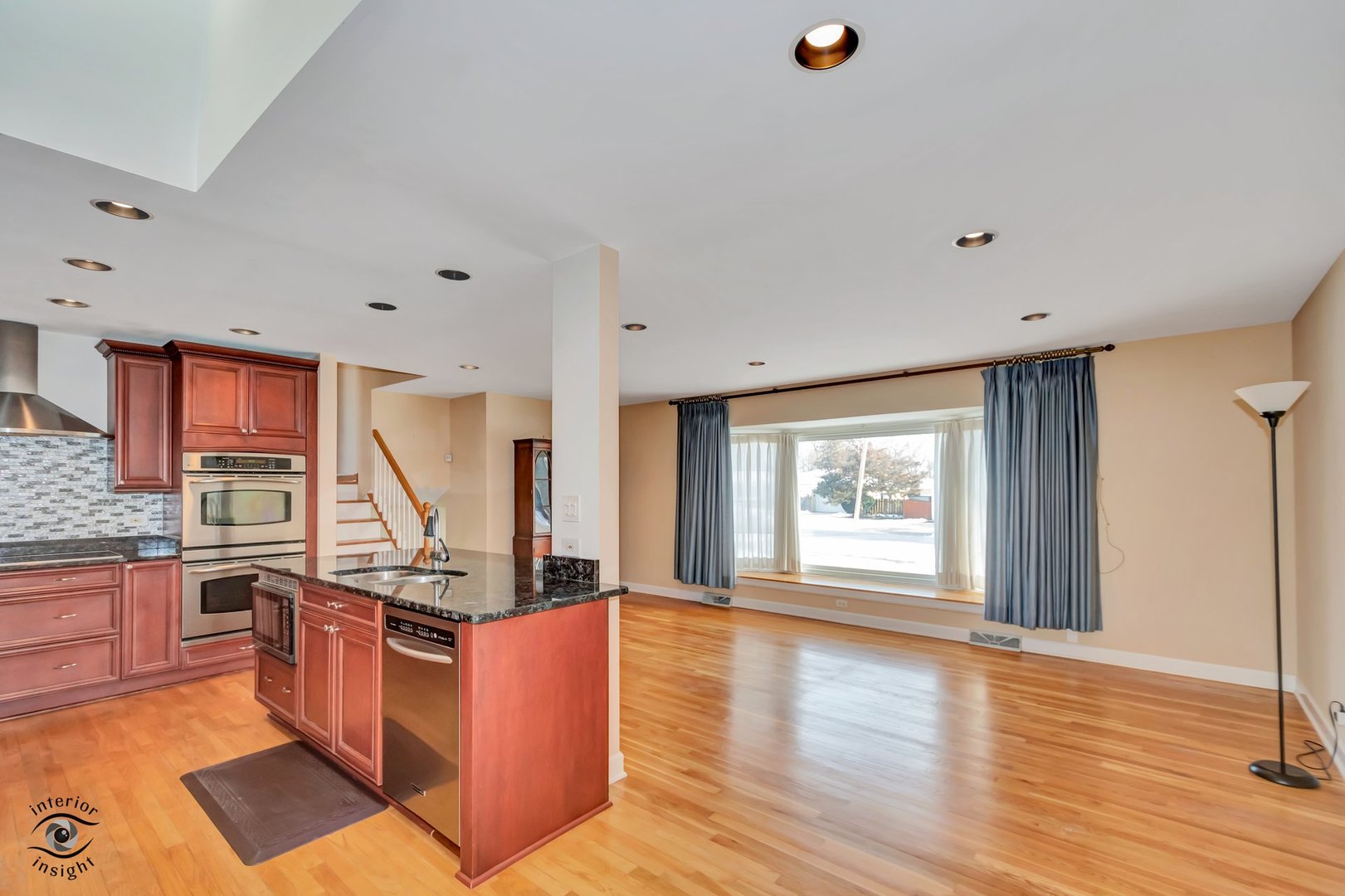 2815 Helen Drive Glenview, IL 60025 - Photo 13 of 40 a open kitchen with stainless steel appliances granite countertop a stove top oven a sink dishwasher and wooden cabinets with wooden floor