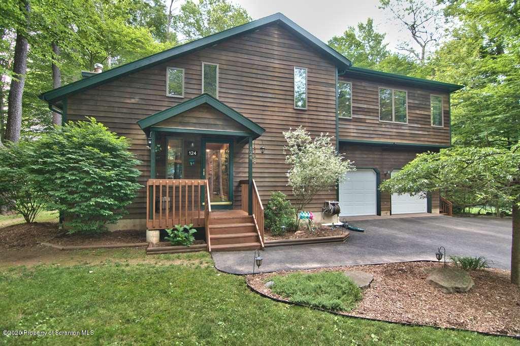 124 Anna Road Pocono Lake, PA 18347 - Photo 1 of 63 a front view of a house with garden
