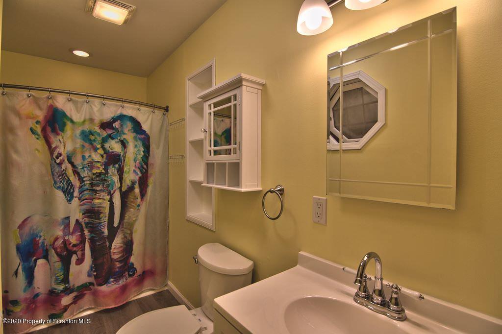124 Anna Road Pocono Lake, PA 18347 - Photo 35 of 63 a bathroom with a toilet sink and mirror