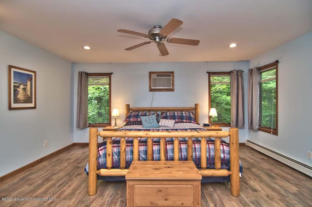 124 Anna Road Pocono Lake, PA 18347 - Photo 38 of 63 a bedroom with furniture and a window