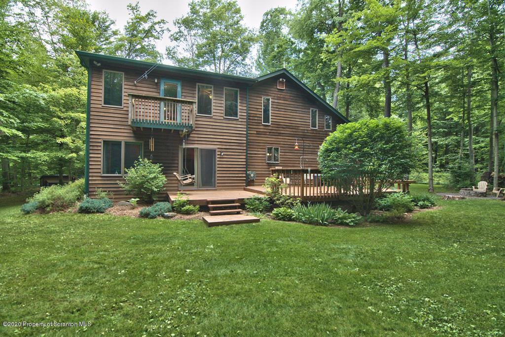 124 Anna Road Pocono Lake, PA 18347 - Photo 54 of 63 a view of a house with a yard and sitting area