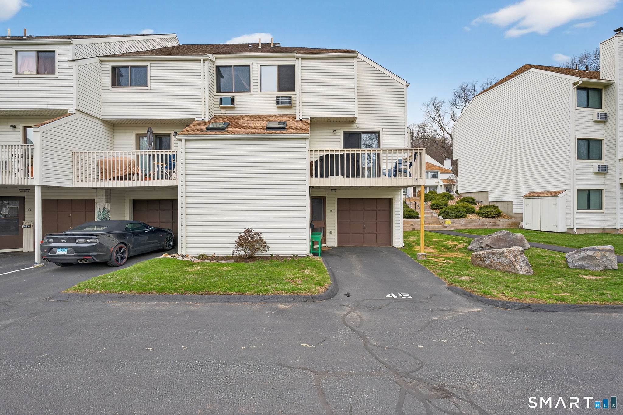 85 North Main Street, Unit 45 East Hampton, CT 06424 - Photo 1 of 1 a front view of a house with a yard and garage
