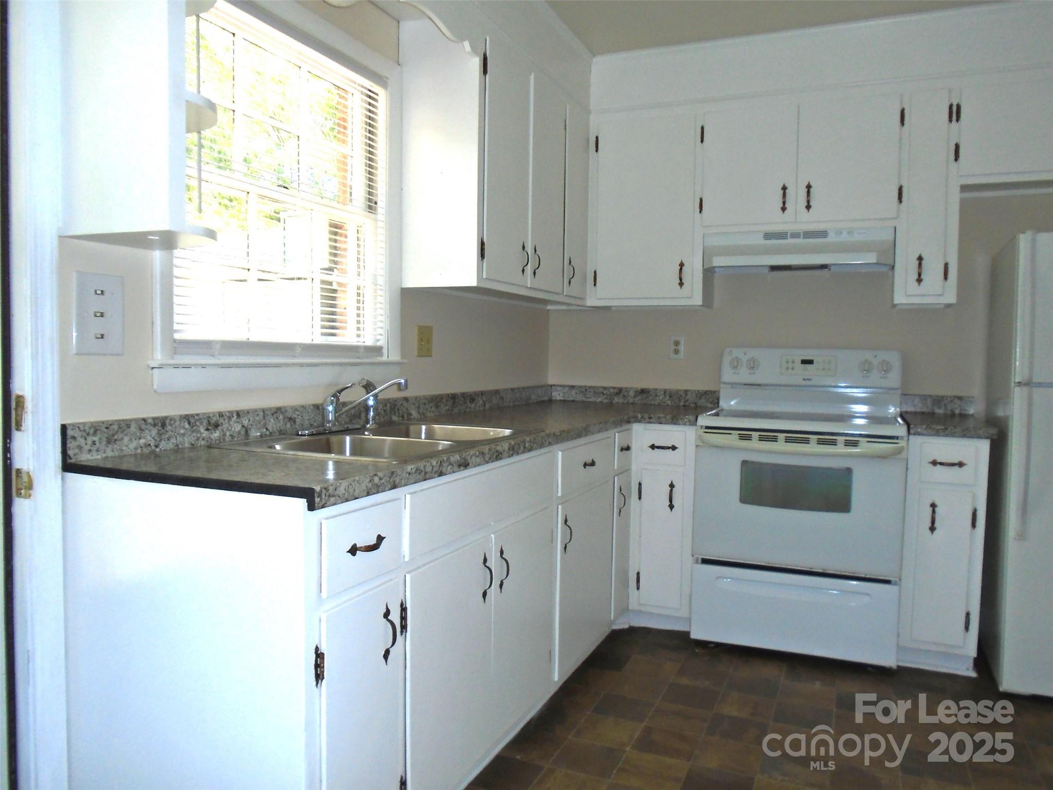 4227 Walker Road, Unit 1 Charlotte, NC 28211 - Photo 2 of 9 a kitchen with granite countertop white cabinets and white appliances