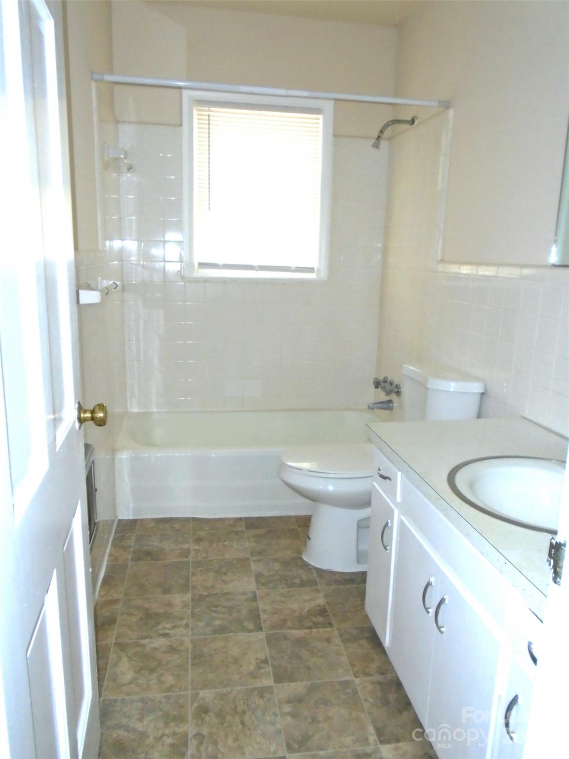 4227 Walker Road, Unit 1 Charlotte, NC 28211 - Photo 7 of 9 a bathroom with a sink a toilet and a bathtub