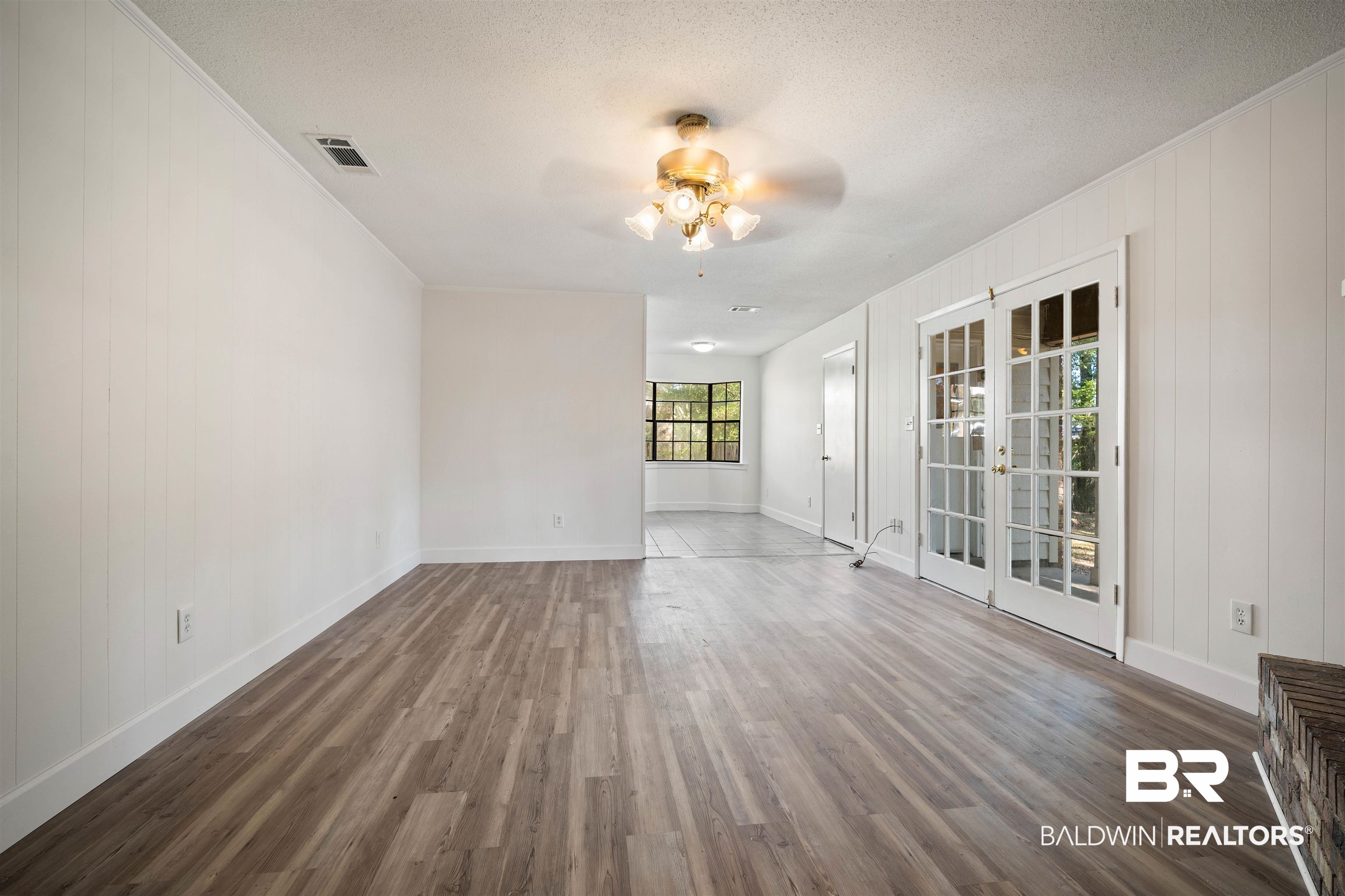 6521 Valor Court Mobile, AL 36618 - Photo 5 of 29 Unfurnished room featuring ceiling fan, a textured ceiling, dark hardwood / wood-style floors, and french doors