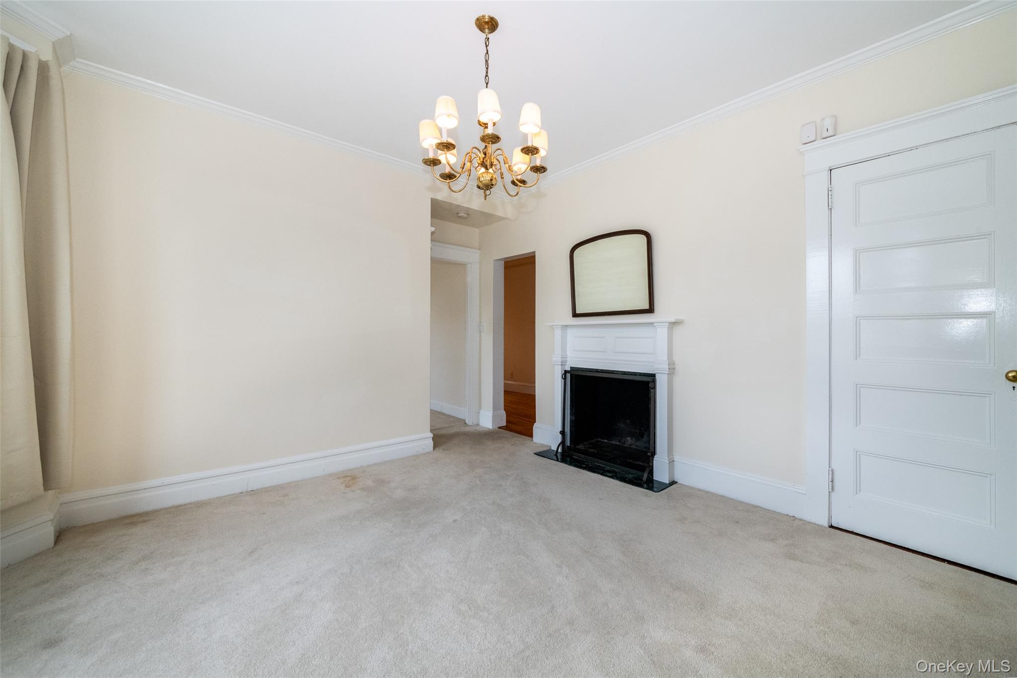 82 Clove Road New Rochelle, NY 10801 - Photo 7 of 39 a view of a fireplace with a chandelier