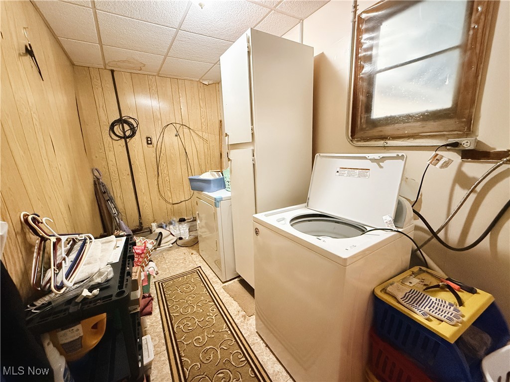 4185 Tapper Road Barberton, OH 44203 - Photo 16 of 23 Laundry room with wood walls and cabinet space