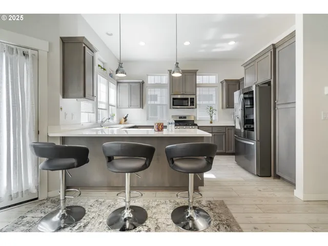 a kitchen with stainless steel appliances kitchen island granite countertop a sink and cabinets