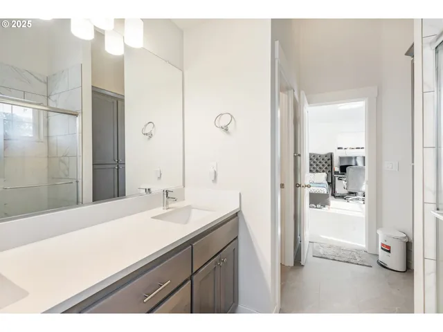 a bathroom with a sink a mirror and a shower