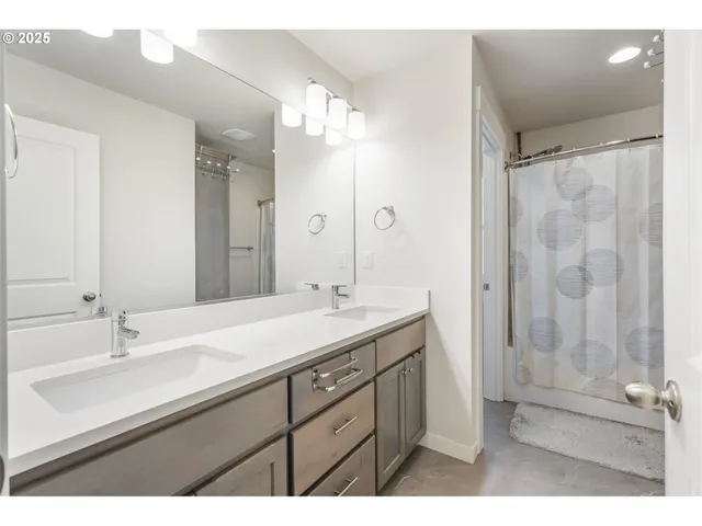 a bathroom with a sink a toilet and mirror