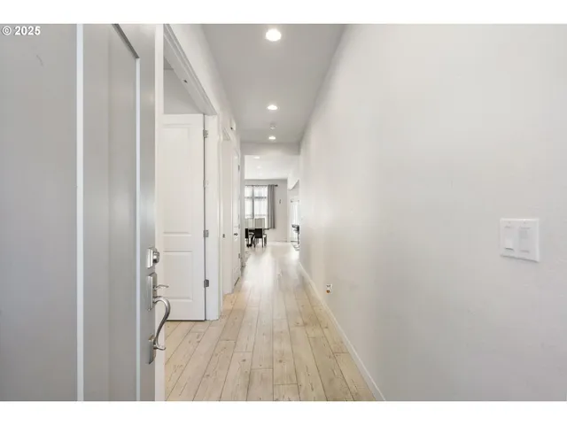 a view of hallway with wooden floor