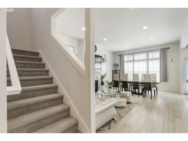 a view of dining room and livingroom with lots of furniture and wooden floor