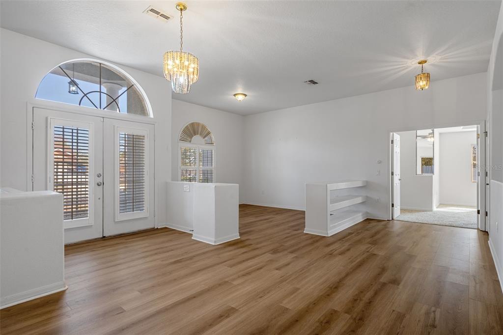 7285 Nightwalker Road Weeki Wachee, FL 34613 - Photo 12 of 79 a view of a room with wooden floor chandelier and windows