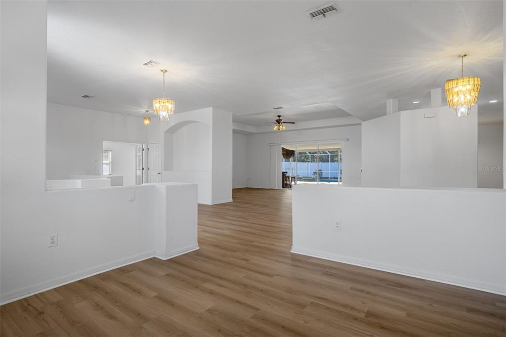 7285 Nightwalker Road Weeki Wachee, FL 34613 - Photo 13 of 79 a view of kitchen and hall with wooden floor