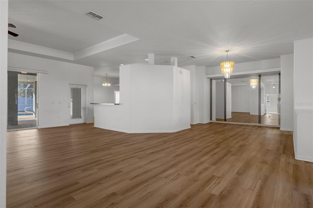 7285 Nightwalker Road Weeki Wachee, FL 34613 - Photo 14 of 79 a view of empty room with wooden floor