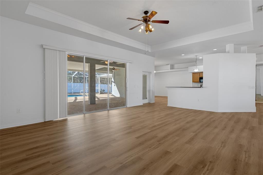 7285 Nightwalker Road Weeki Wachee, FL 34613 - Photo 21 of 79 a view of empty room with wooden floor and fan