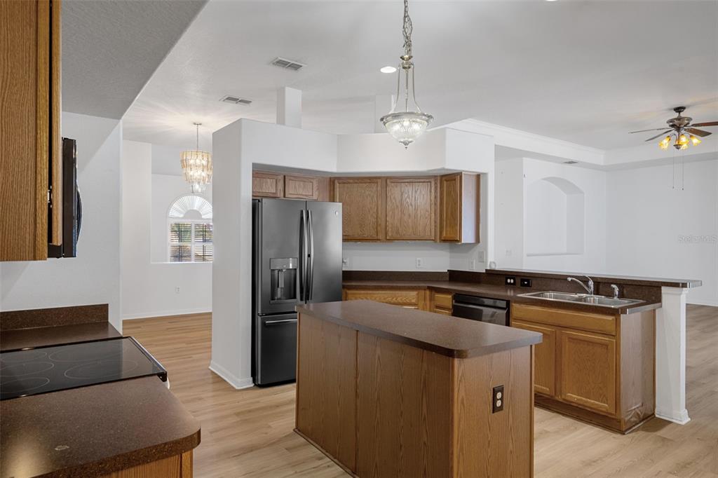 7285 Nightwalker Road Weeki Wachee, FL 34613 - Photo 26 of 79 a kitchen with stainless steel appliances granite countertop a refrigerator a stove and a refrigerator