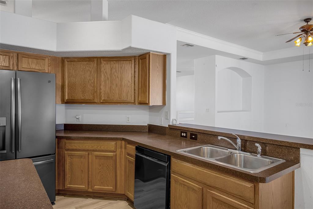 7285 Nightwalker Road Weeki Wachee, FL 34613 - Photo 28 of 79 a kitchen with granite countertop a sink stove and refrigerator