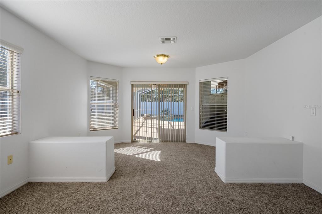 7285 Nightwalker Road Weeki Wachee, FL 34613 - Photo 35 of 79 a living room with furniture and windows
