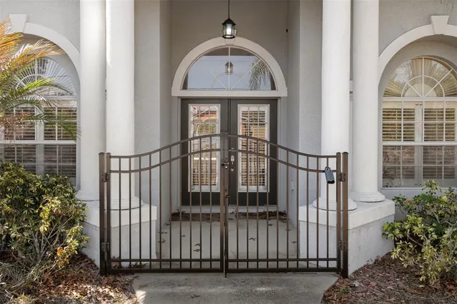 an empty room with wooden floor cabinet and windows