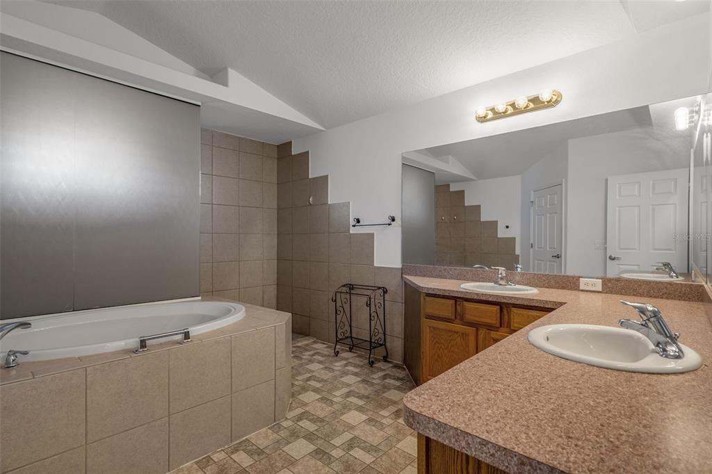7285 Nightwalker Road Weeki Wachee, FL 34613 - Photo 41 of 79 a bathroom with a granite countertop sink a toilet and mirror