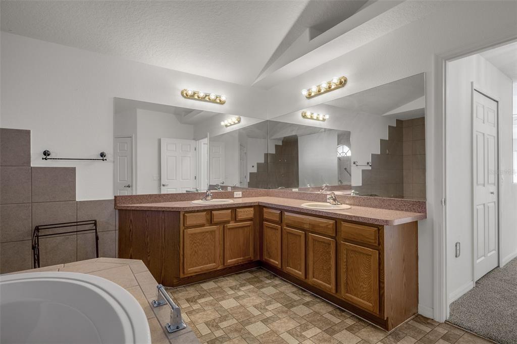 7285 Nightwalker Road Weeki Wachee, FL 34613 - Photo 42 of 79 a large bathroom with a sink and a large mirror