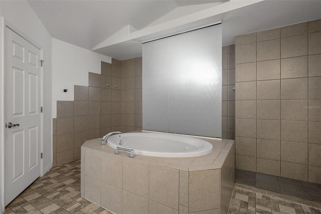 7285 Nightwalker Road Weeki Wachee, FL 34613 - Photo 44 of 79 a white bath tub sitting in a bathroom