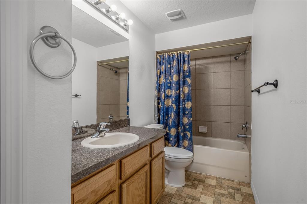 7285 Nightwalker Road Weeki Wachee, FL 34613 - Photo 49 of 79 a bathroom with a granite countertop sink toilet and shower