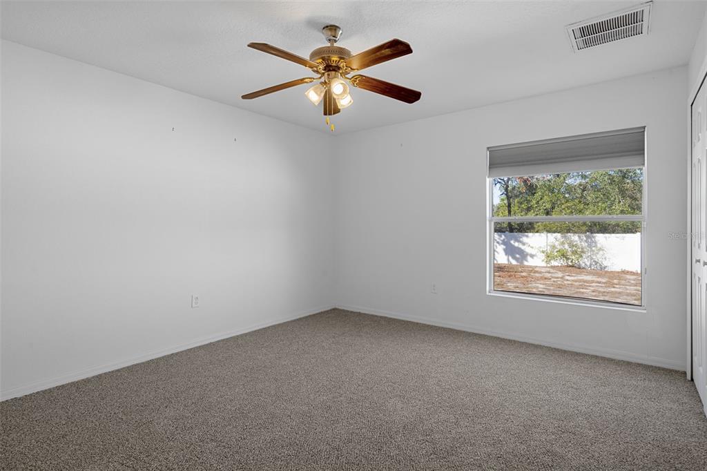 7285 Nightwalker Road Weeki Wachee, FL 34613 - Photo 54 of 79 an empty room with a window and a fan