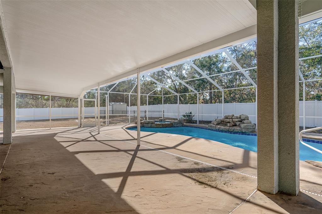 7285 Nightwalker Road Weeki Wachee, FL 34613 - Photo 61 of 79 a room with lots of windows and wooden fence