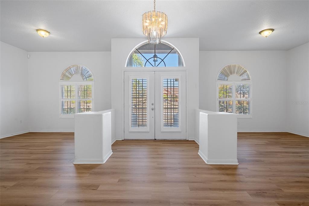 7285 Nightwalker Road Weeki Wachee, FL 34613 - Photo 7 of 79 a view of an empty room with a window and wooden floor