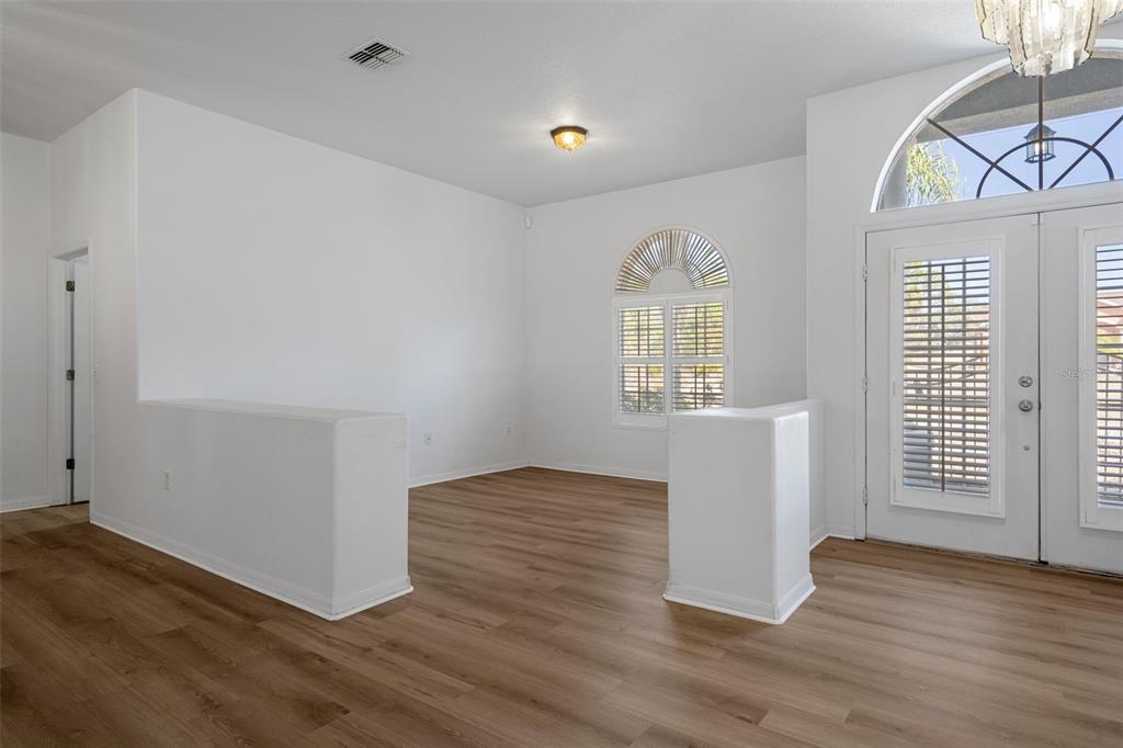 7285 Nightwalker Road Weeki Wachee, FL 34613 - Photo 8 of 79 an empty room with wooden floor and windows