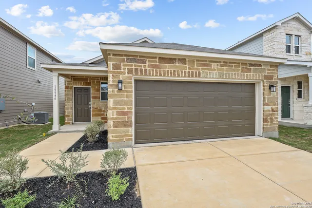 a front view of a house with garage