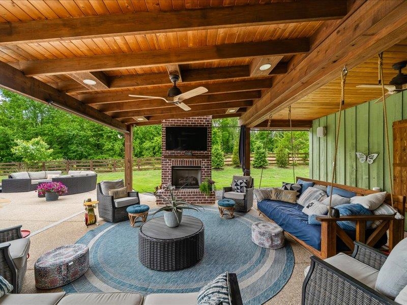 8104 Jack Bond Road Arlington, TN 38002 - Photo 25 of 40 a living room with patio furniture and a fireplace