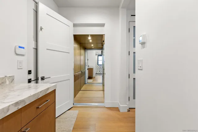 a view of a hallway with wooden floor and entryway