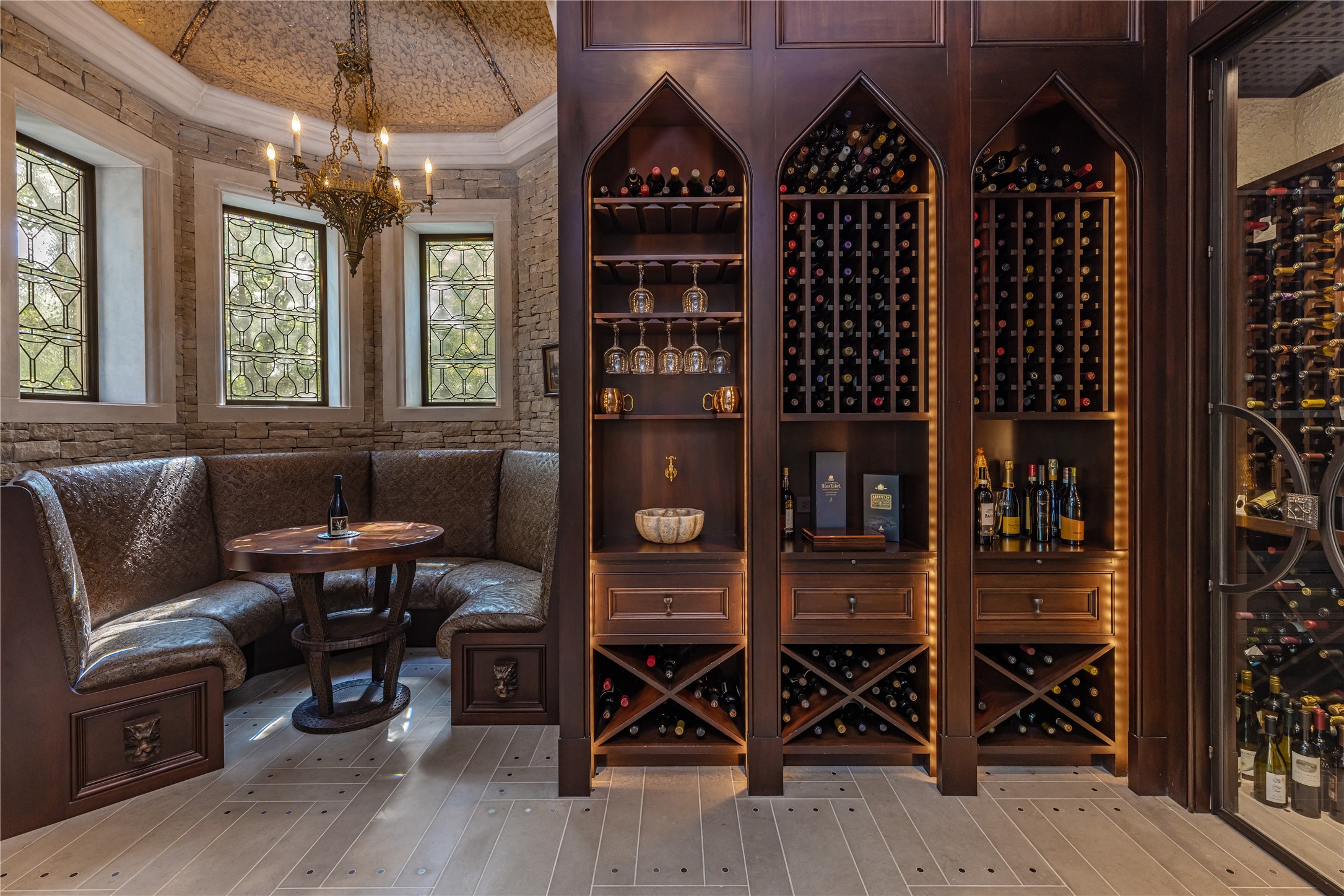107 Timberwilde Lane Houston, TX 77024 - Photo 14 of 40 A walk-in, climate-controlled wine room with custom racking and ambient lighting creates an intimate setting for tastings, offering both function and atmosphere for wine enthusiasts.
