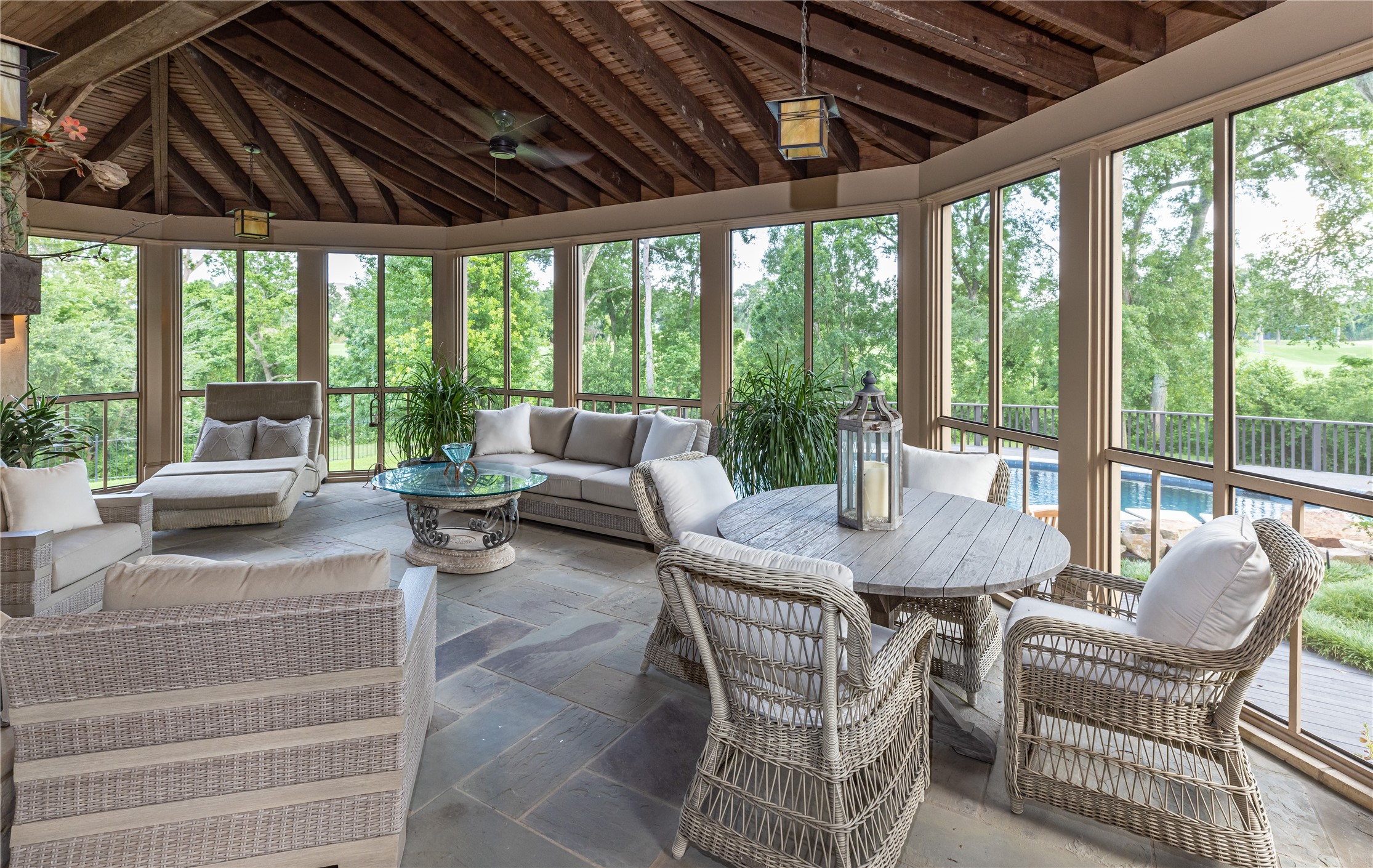107 Timberwilde Lane Houston, TX 77024 - Photo 30 of 40 Every Hill Country–style home must have a screened-in porch, and this one defines the tradition. With stone floors, a beamed ceiling, and a massive wood-burning fireplace, it offers rustic elegance and year-round comfort.