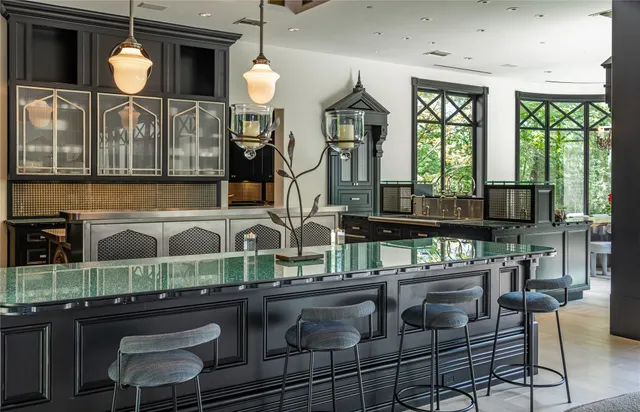 a kitchen with a stove a sink and a dining table