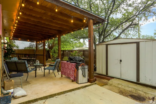a backyard of a house with table and chairs