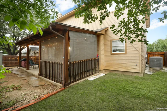 a view of a house with backyard and sitting area