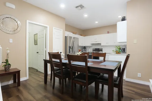 a view of a dining room with furniture and wooden floor