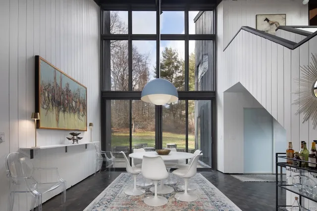 a kitchen with stainless steel appliances granite countertop table chairs sink and cabinets