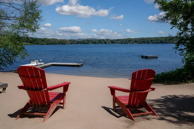 a view of a lake with table and chairs