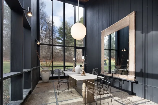 a living room with a large window and furniture